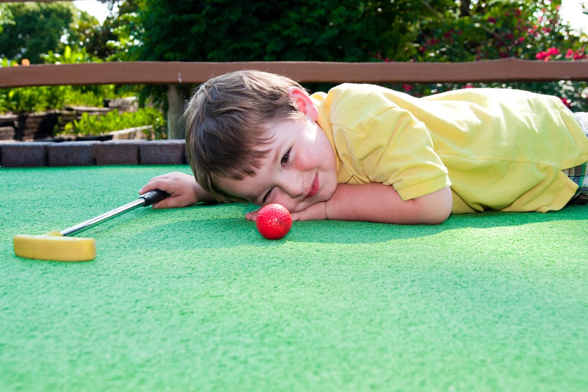 Kid playing Mini Golf at the Wilderness Presidential Resort