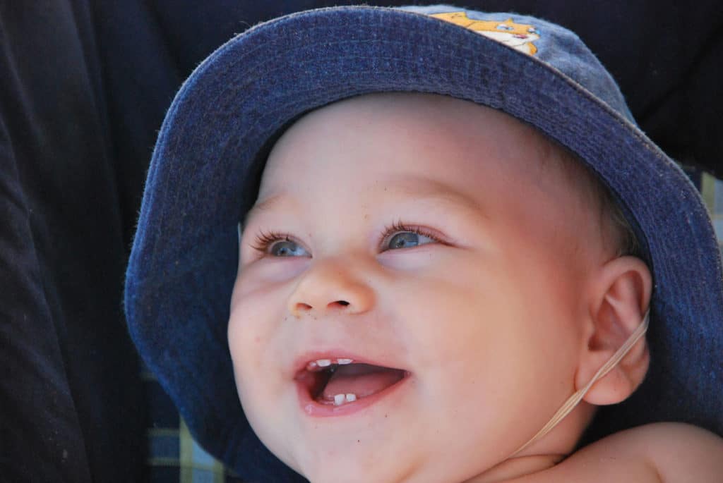 baby wearing hat at Wilderness Presidential Resort