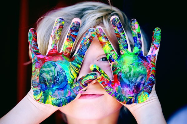 Kids Crafts showing child with hands covered in paint at Wilderness Presidential Resort