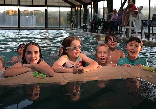 kids swimming in indoor pool